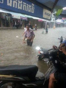 khmer guy walking through flood